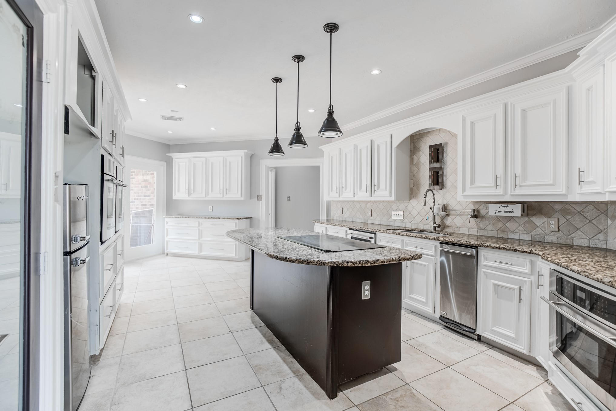 11618 Snowmass Drive Houston, TX 77070 - Photo 12 of 36 a kitchen with stainless steel appliances granite countertop a sink stove and refrigerator