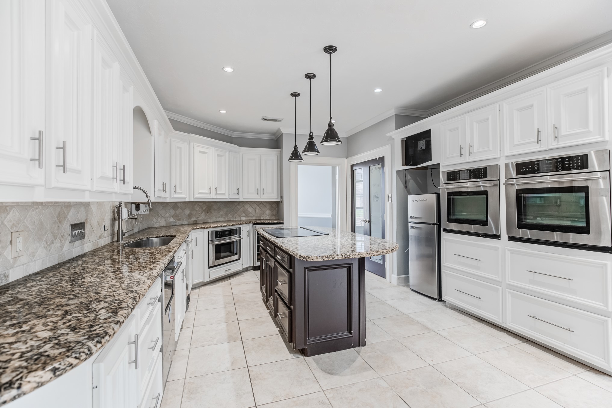 11618 Snowmass Drive Houston, TX 77070 - Photo 14 of 36 a kitchen with stainless steel appliances granite countertop a stove and cabinets