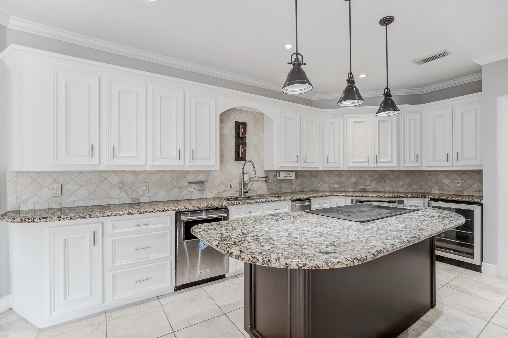 11618 Snowmass Drive Houston, TX 77070 - Photo 15 of 36 a kitchen with granite countertop a sink stainless steel appliances and white cabinets