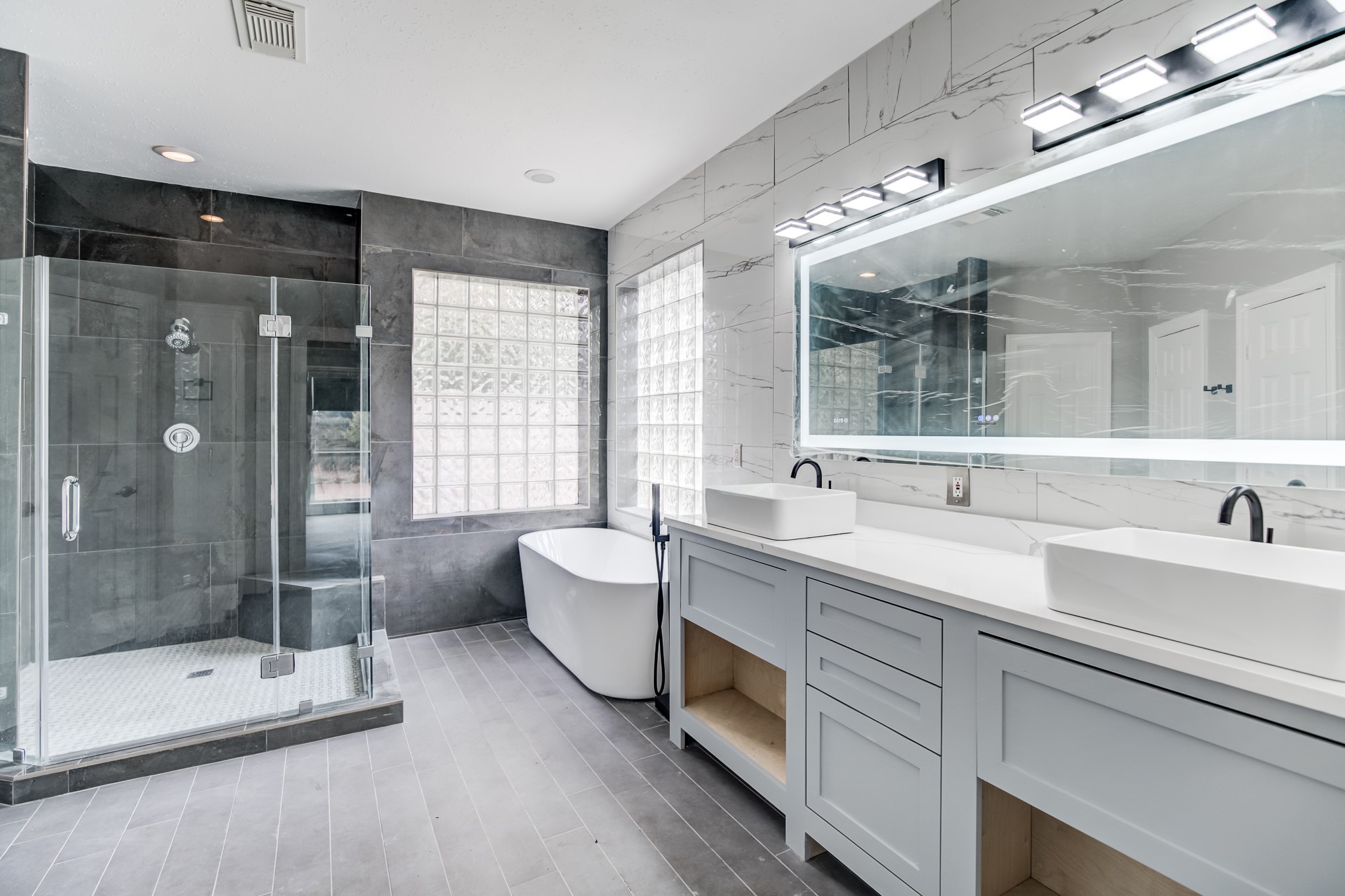 11618 Snowmass Drive Houston, TX 77070 - Photo 23 of 36 a spacious bathroom with a double vanity sink mirror and shower