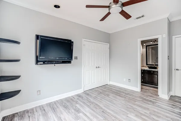 a living room with flat screen tv and kitchen view
