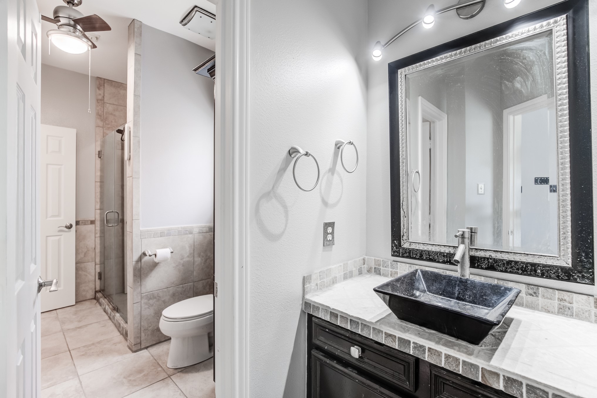 11618 Snowmass Drive Houston, TX 77070 - Photo 28 of 36 a bathroom with a granite countertop sink a toilet and a mirror