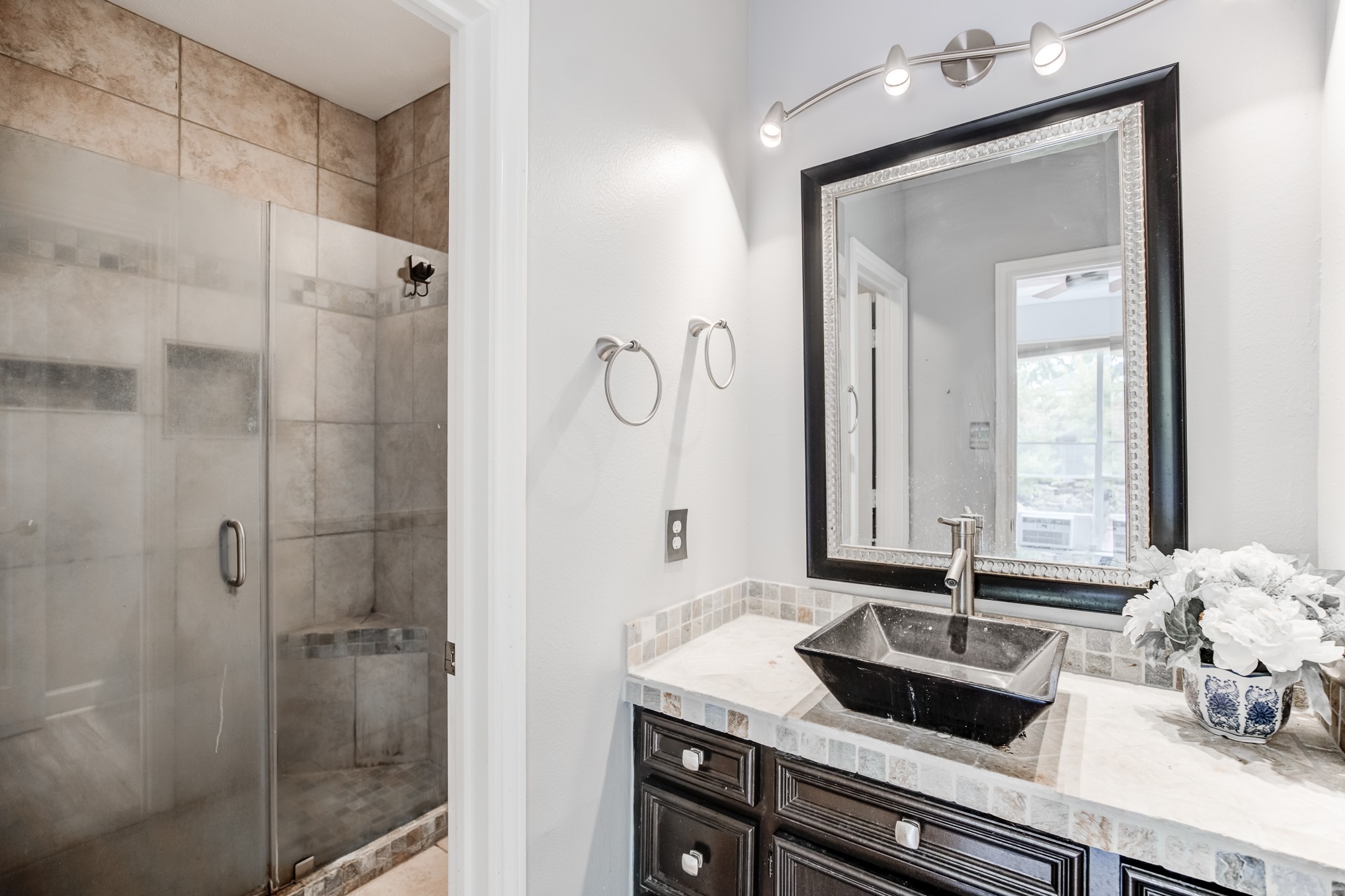 11618 Snowmass Drive Houston, TX 77070 - Photo 29 of 36 a bathroom with a granite countertop sink and a mirror
