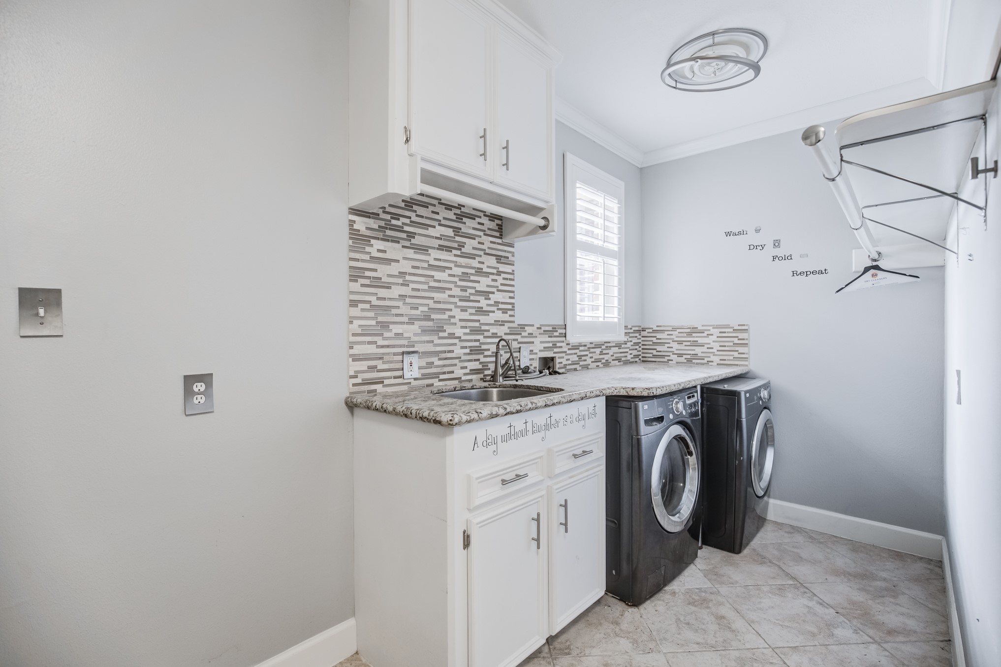 11618 Snowmass Drive Houston, TX 77070 - Photo 33 of 36 a utility room with granite countertop a sink a washer and dryer