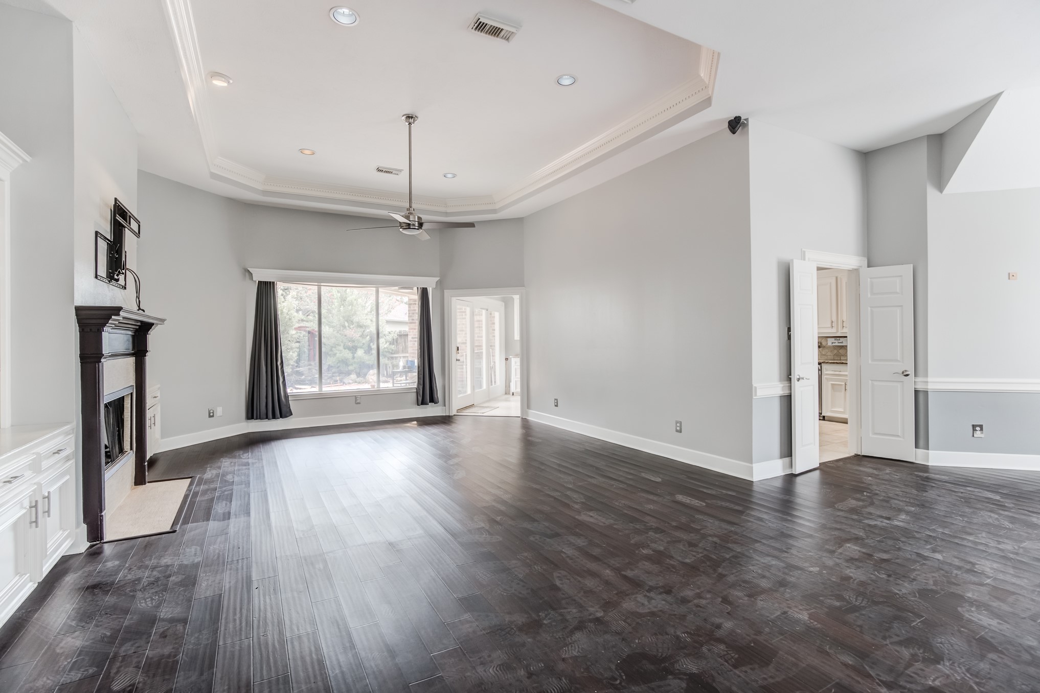 11618 Snowmass Drive Houston, TX 77070 - Photo 9 of 36 an empty room with wooden floor fan and windows