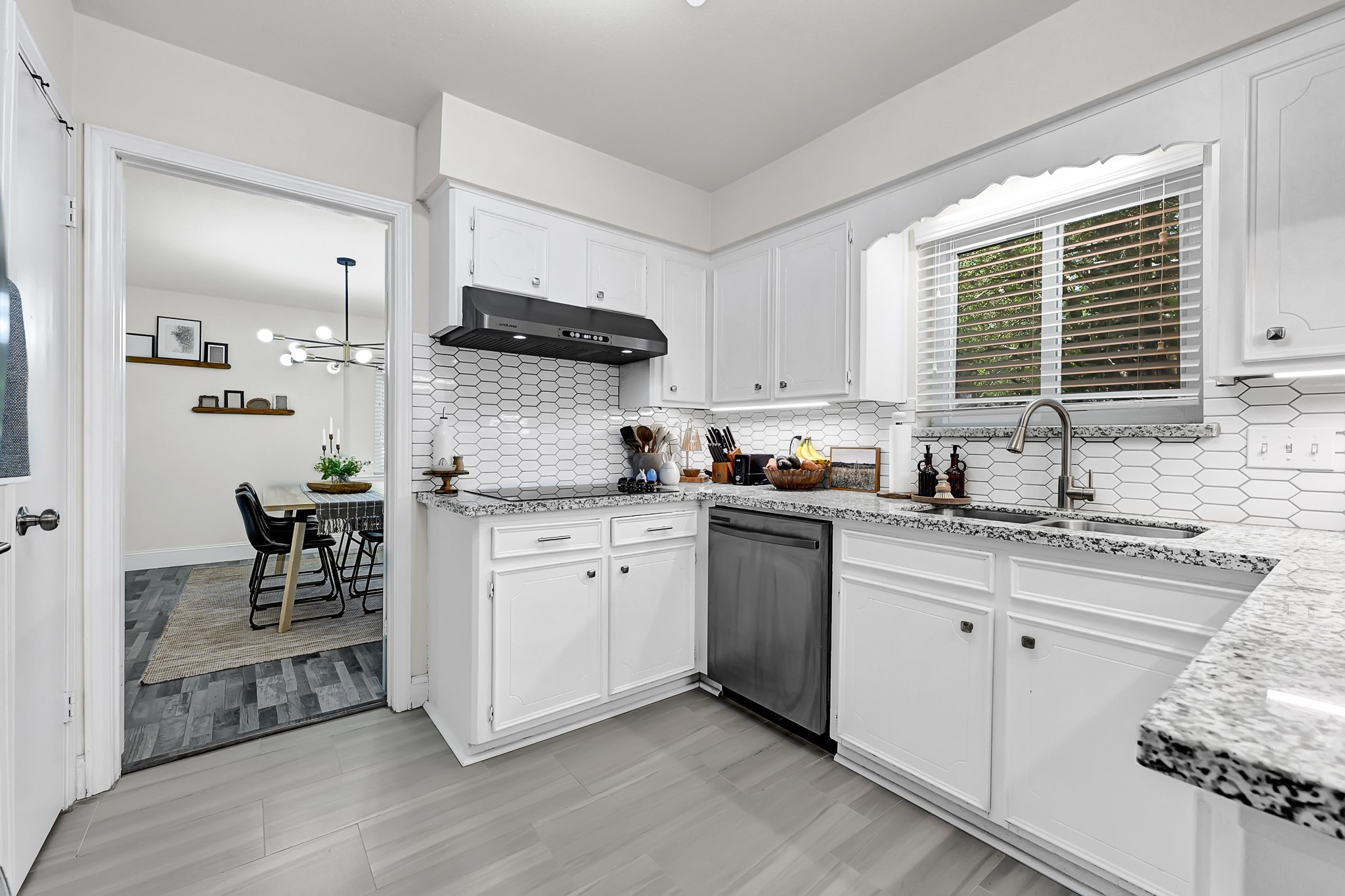 25418 Tuckahoe Lane Spring, TX 77373 - Photo 12 of 26 a kitchen with granite countertop white cabinets a sink a window and stainless steel appliances