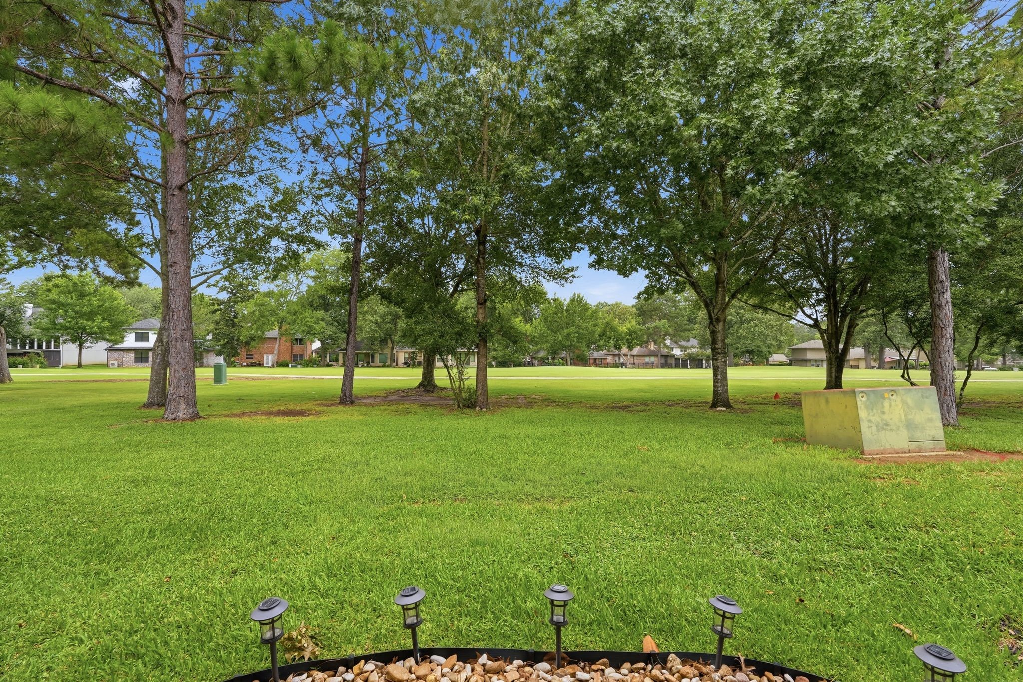 13151 Walden Road, Unit 131 Montgomery, TX 77356 - Photo 21 of 35 Expansive community green space with mature trees and a park-like setting.