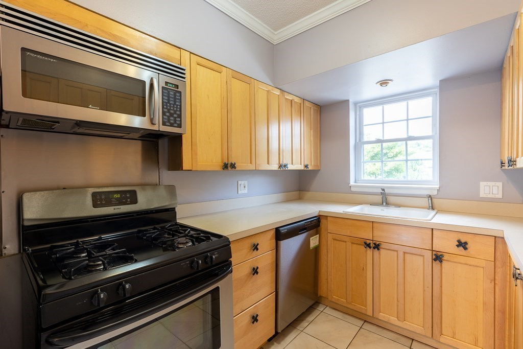 177 Lake Shore Road, Unit 3 Boston, MA 02135 - Photo 3 of 20 a kitchen with a stove and a microwave