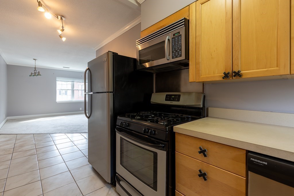 177 Lake Shore Road, Unit 3 Boston, MA 02135 - Photo 5 of 20 a kitchen with a stove cabinets and a refrigerator