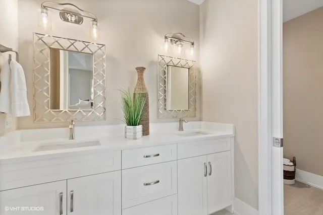 a bathroom with a double vanity sink and a mirror