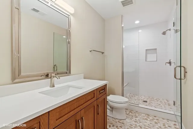 a bathroom with a sink toilet and shower