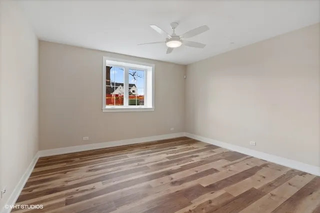 a view of a room with wooden floor and window