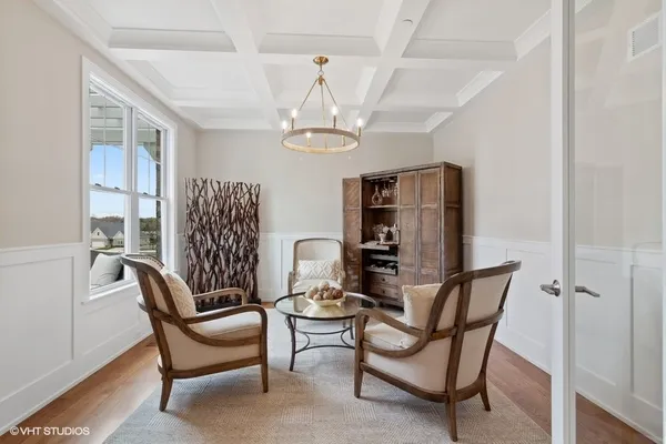 a view of a dining room with furniture and a chandelier