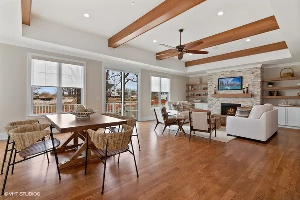 a view of a livingroom with furniture a fireplace and wooden floor