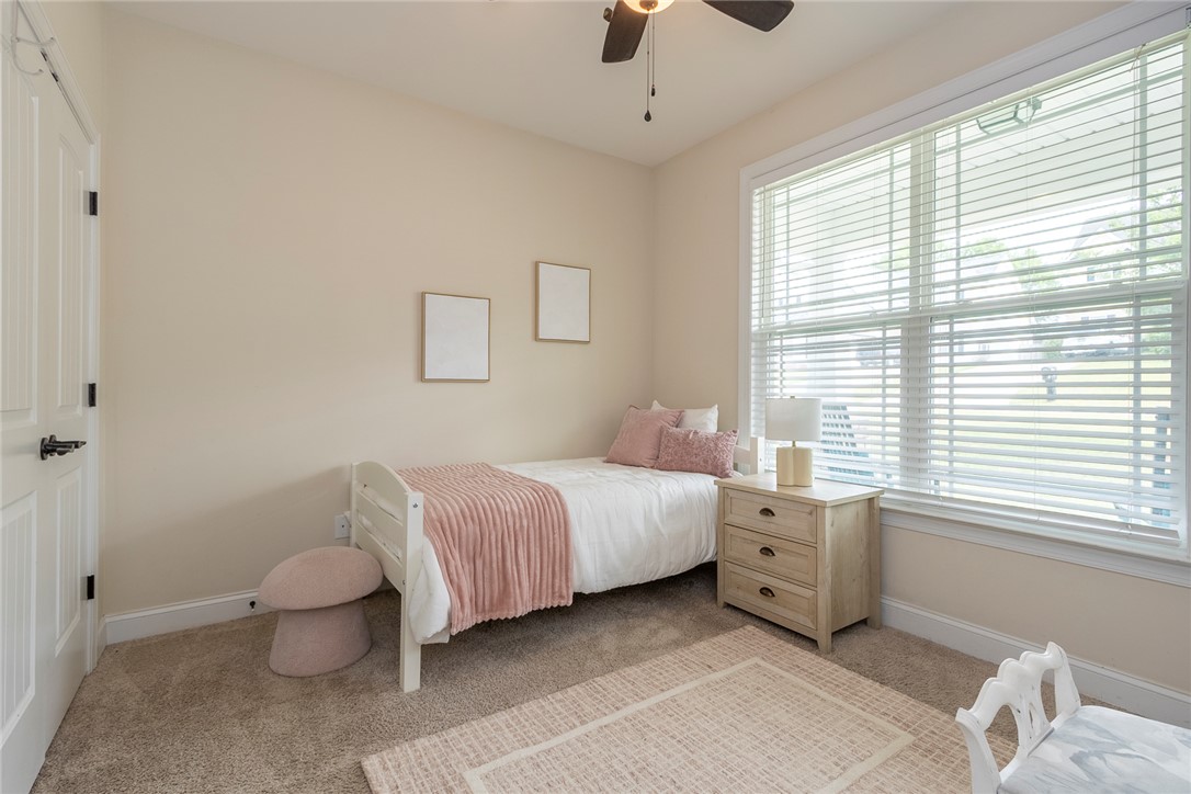 234 Streams Way Anderson, SC 29625 - Photo 15 of 44 This cozy bedroom features carpet flooring and a ceiling fan, creating a comfortable and inviting atmosphere.