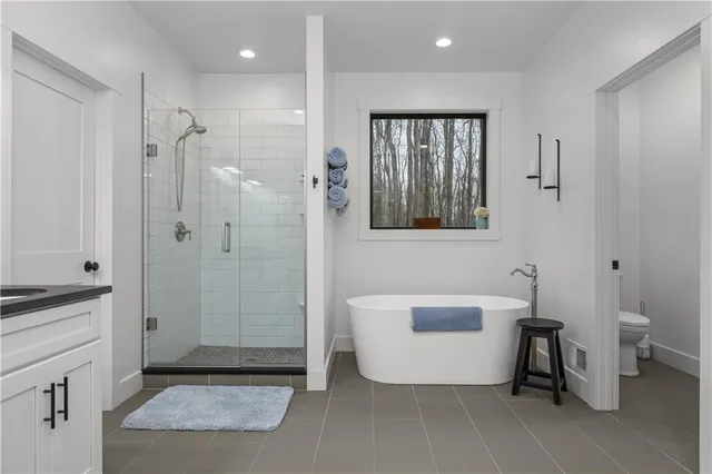 a bathroom with a tub shower and sink