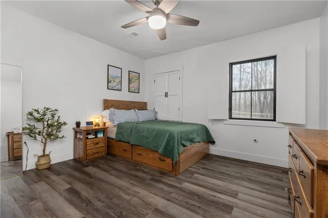 a bedroom with a large bed and a chandelier