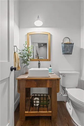 a bathroom with a sink a toilet and mirror
