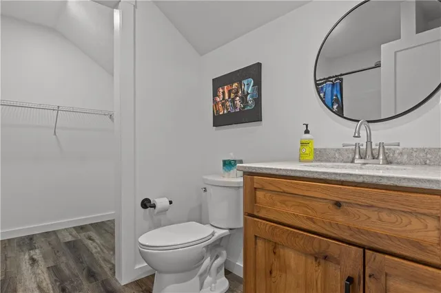 a bathroom with a toilet a sink and a mirror