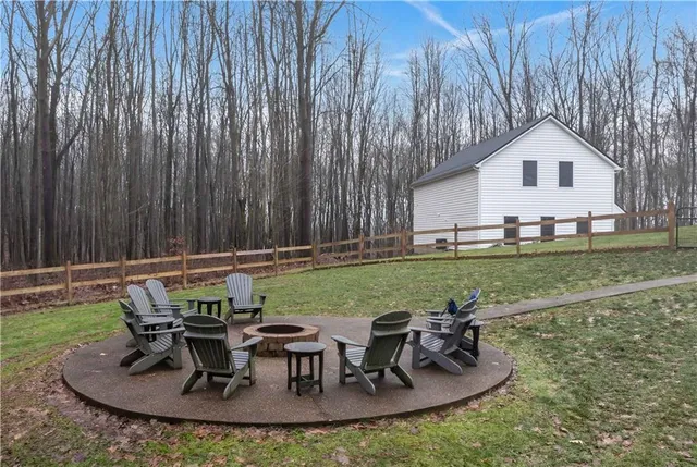 a view of a house with backyard and sitting area