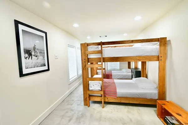a bedroom with furniture and a large window