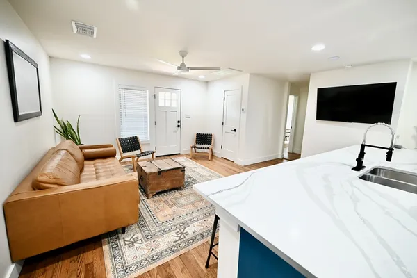 a living room with furniture and a flat screen tv