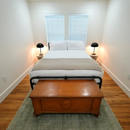 a bedroom with a bed and window