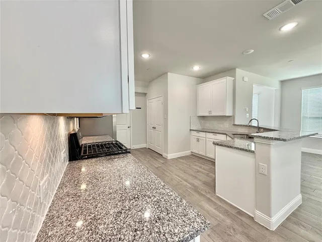 a kitchen with stainless steel appliances granite countertop a sink and cabinets