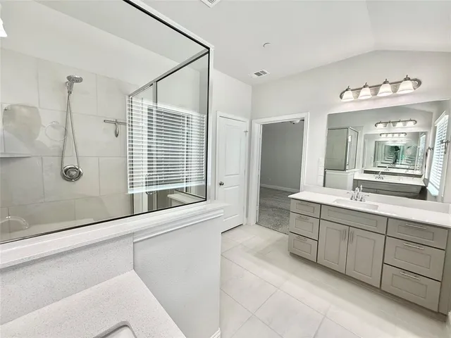 a bathroom with a tub sink and a mirror