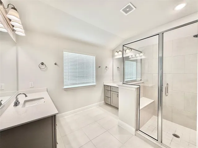 a bathroom with a tub sink and mirror