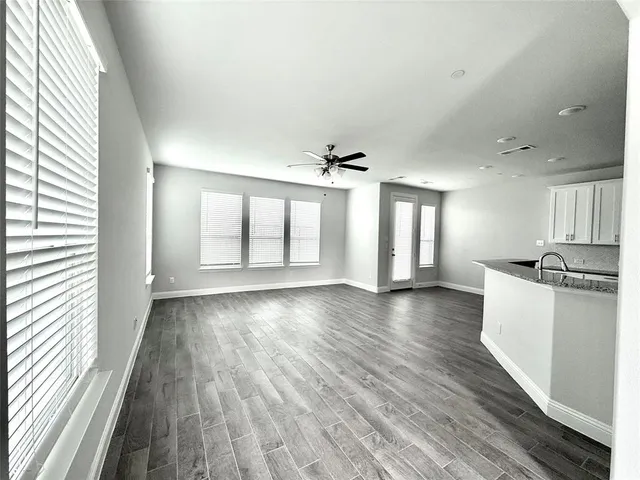 a view of a kitchen with wooden floor and electronic appliances