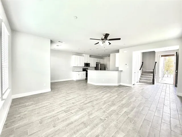 a view of a bedroom with a large bed and lamp