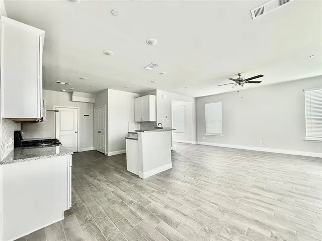a view of a kitchen with a sink and a refrigerator