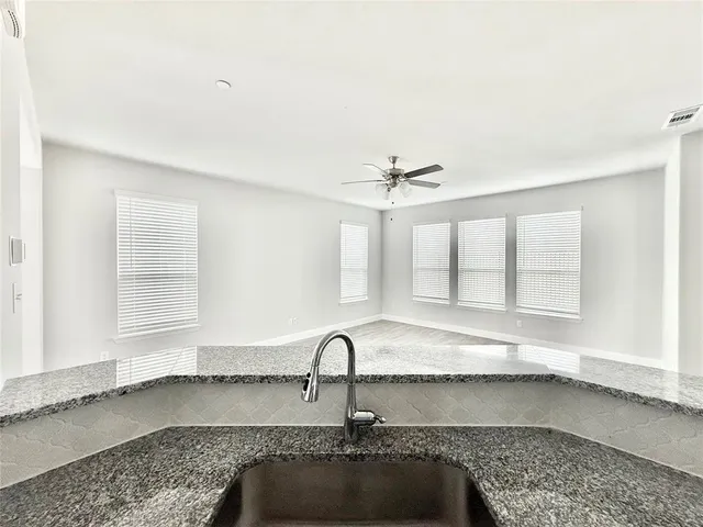 a kitchen with granite countertop a sink and a window