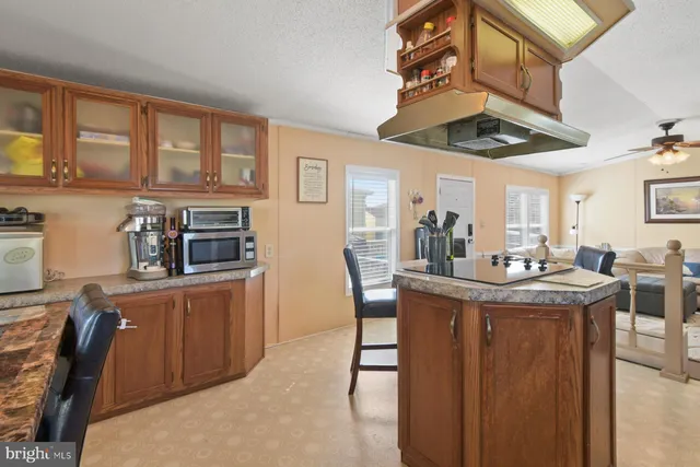 a view of a kitchen area with furniture and wooden floor