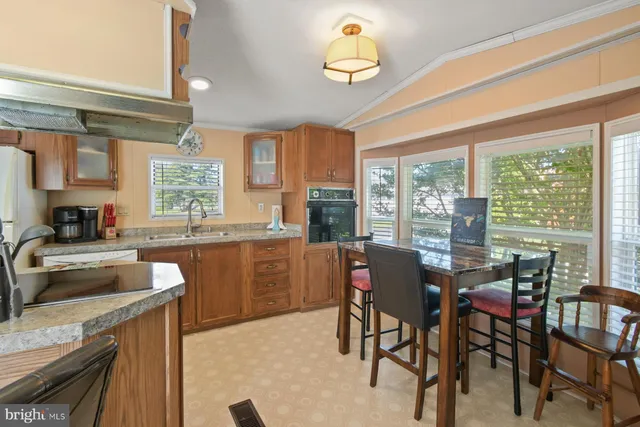 a kitchen with a table chairs and microwave