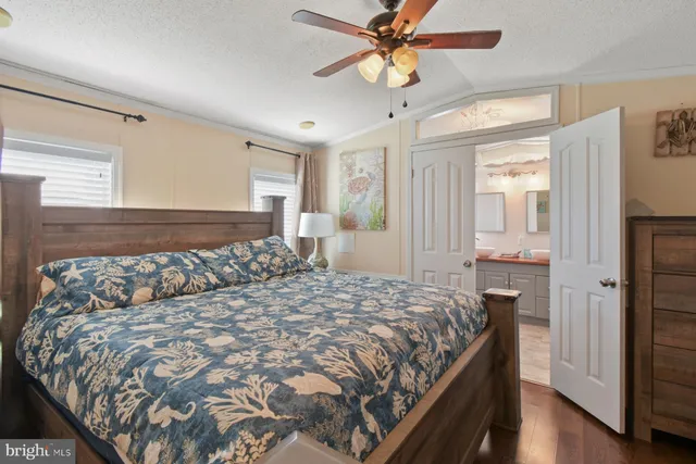 a bedroom with a large bed and a chandelier