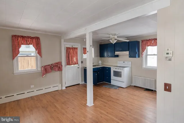 a kitchen with stainless steel appliances a stove top oven a sink dishwasher and a refrigerator