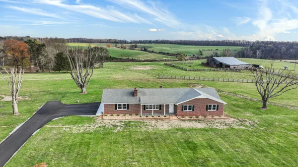 an aerial view of a house with big yard