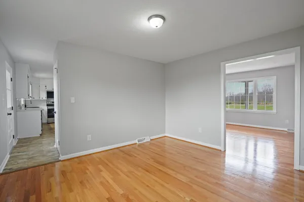 wooden floor in an empty room with a window