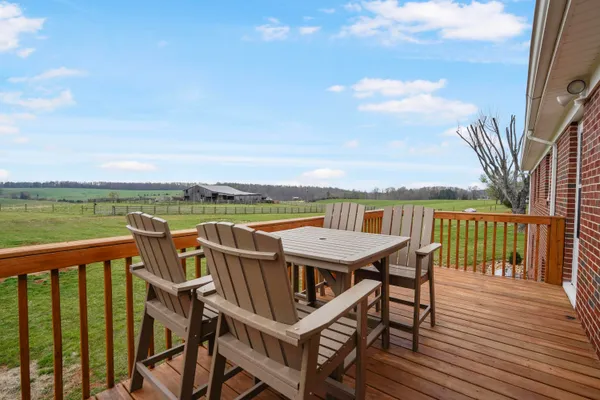 a view of a balcony with wooden chairs and wooden floor
