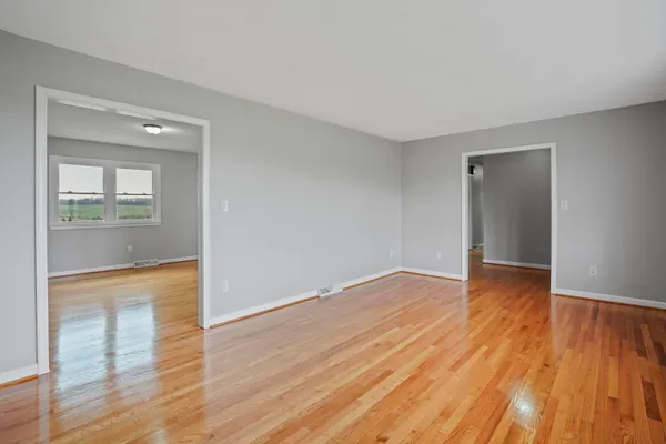 wooden floor in an empty room with a window