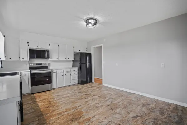 a kitchen with stainless steel appliances a refrigerator sink and stove