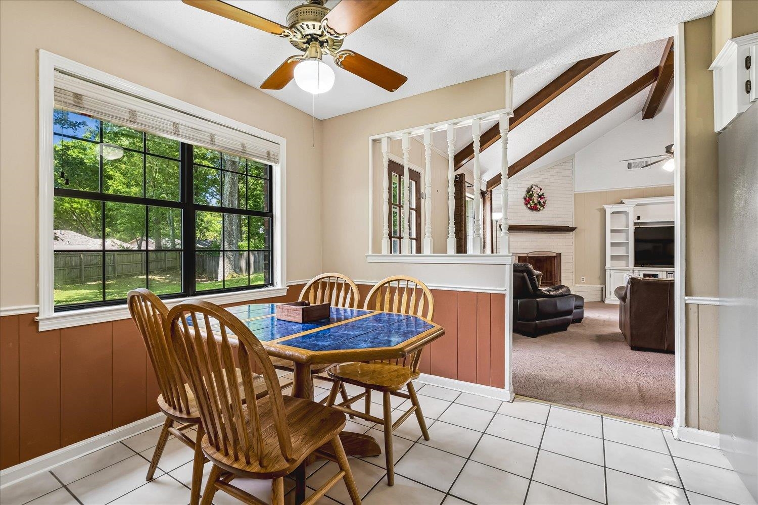 5711 Yale Road Bartlett, TN 38134 - Photo 8 of 29 Dining area featuring tile flooring, a large window with exterior backyard scenery, and a ceiling fan