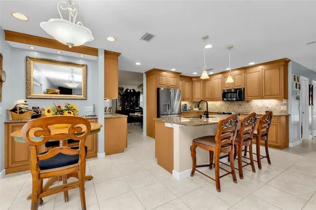 a bathroom with a granite countertop sink a mirror a shower and a bathtub