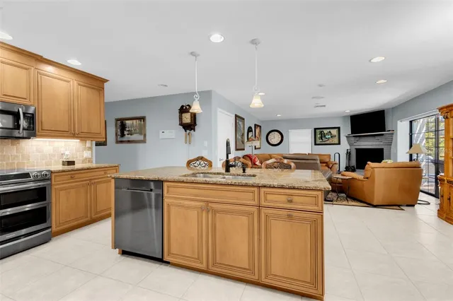 a bedroom with a bed a dresser and next to a window