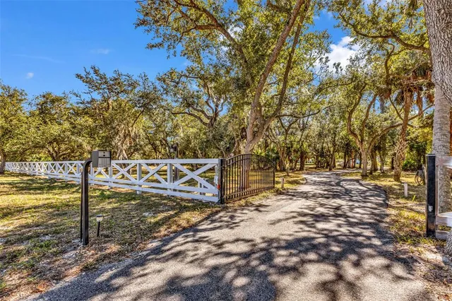 a view of a yard with wooden fence