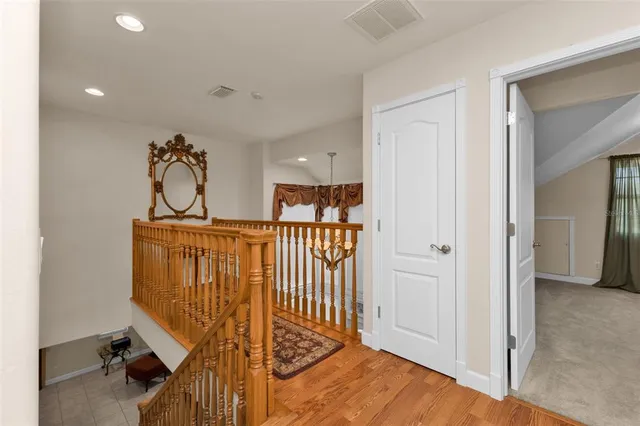 an aerial view of a house with a yard and wooden fence