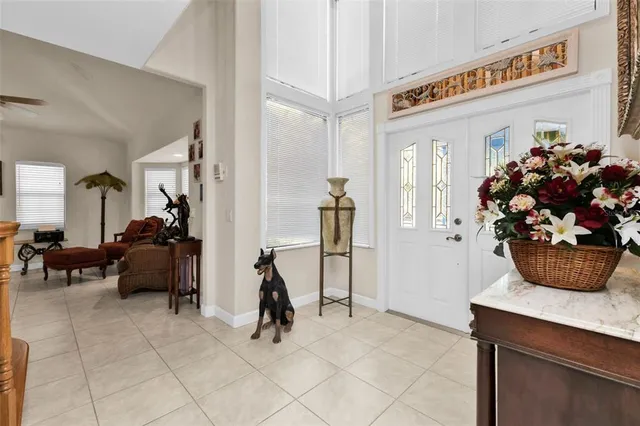 a dining room with furniture potted plants and wooden floor