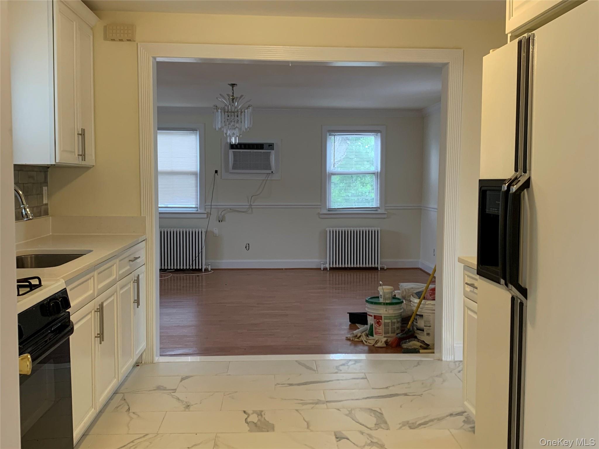 7 Clinton Street Haverstraw, NY 10927 - Photo 6 of 20 Kitchen featuring white cabinetry, light-toned countertops, and marble-look floor tiling